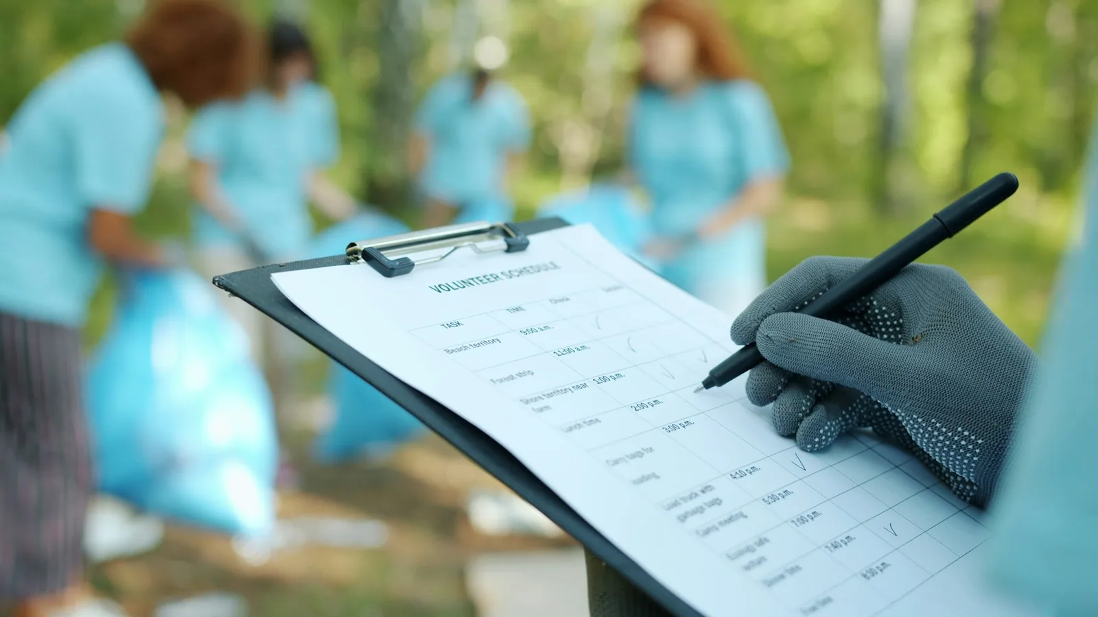 Field researcher filling in a printed survey form on a clipboard on location